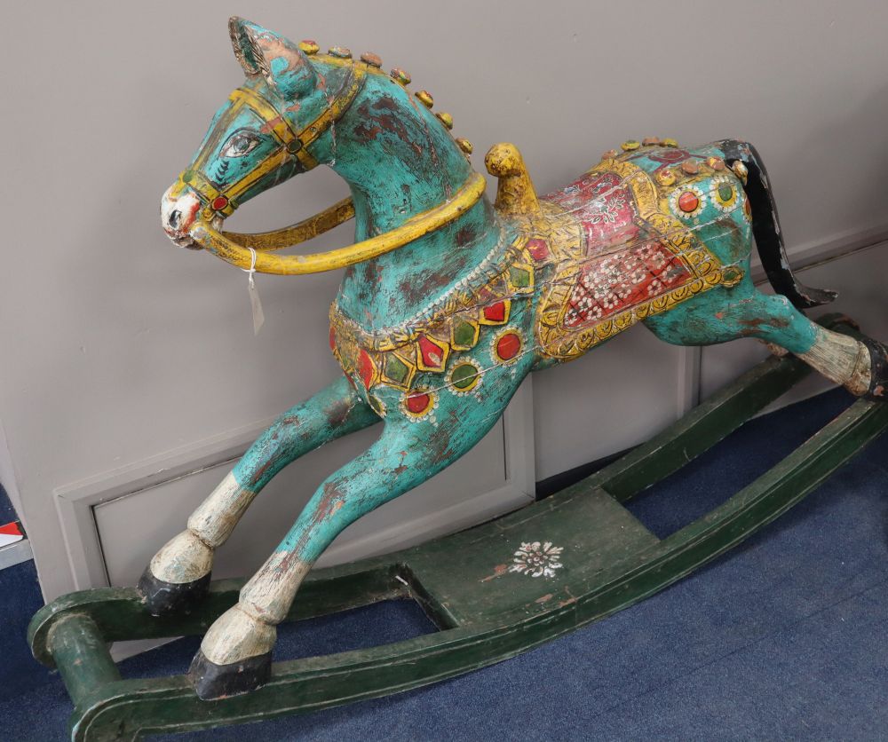 An Indian painted carved hardwood rocking horse, L.160cm, H.104cm